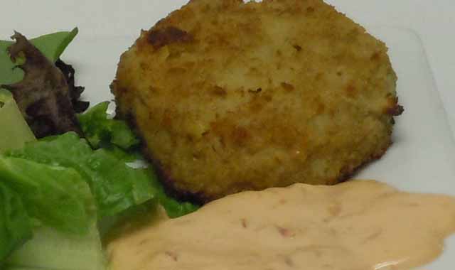 Handmade crabcakes in a red pepper and mayonnaise remoulade
